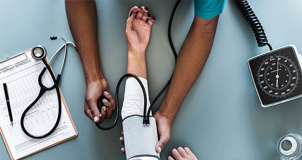 Patient getting blood pressure checked from a nurse