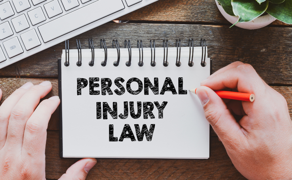 computer and notebook with the words personal injury law